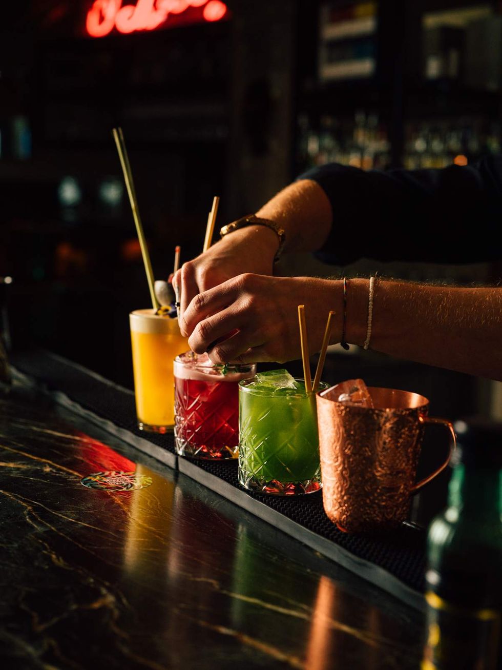 Four cocktails lined up at a bar in Vienna
