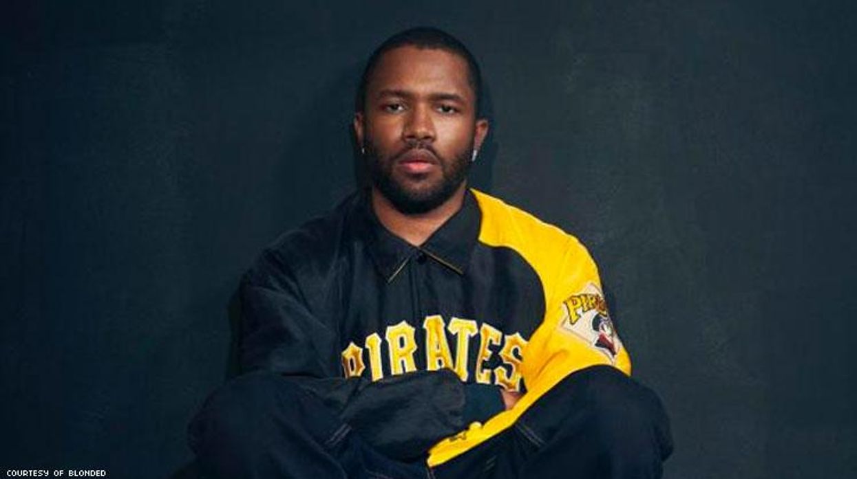 Frank Ocean sitting on the ground.