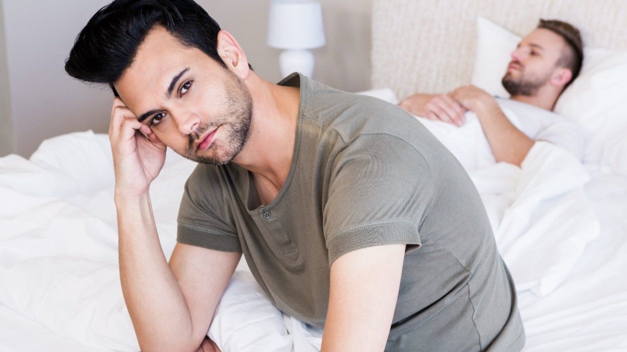 Gay couple in bedroom at home