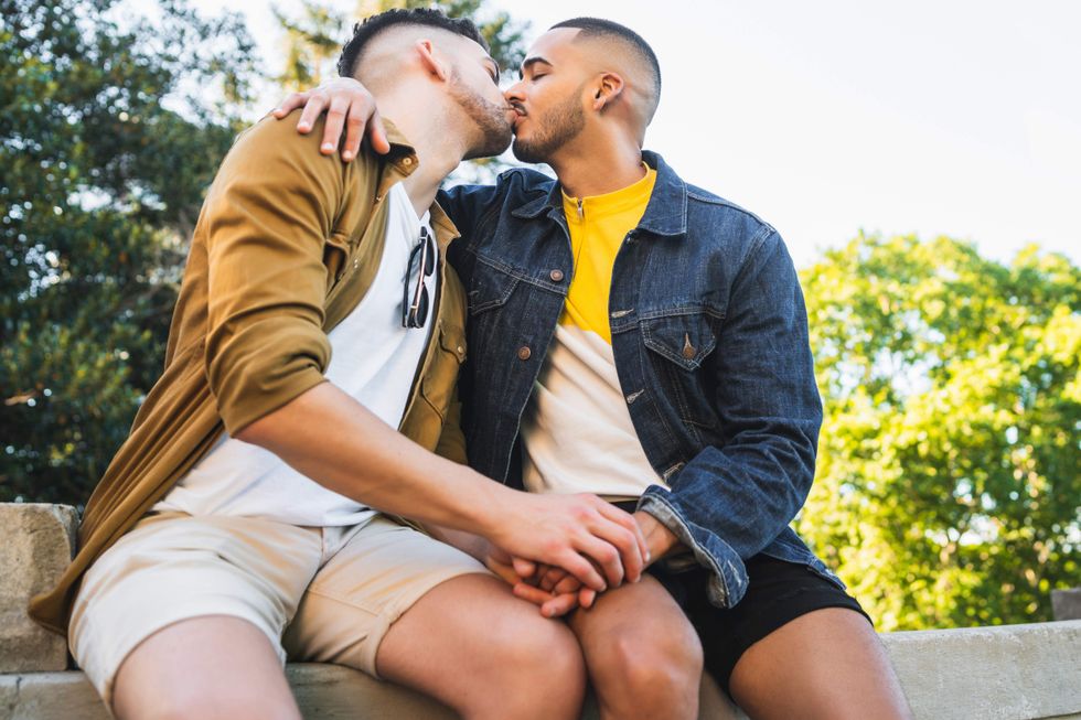 Gay couple kissing and holding hands