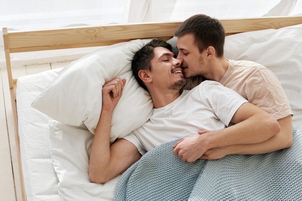 Gay couple spooning in bed
