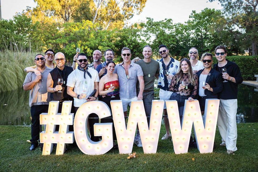 Gay Wine Weekend guests raise a glass for a group photo