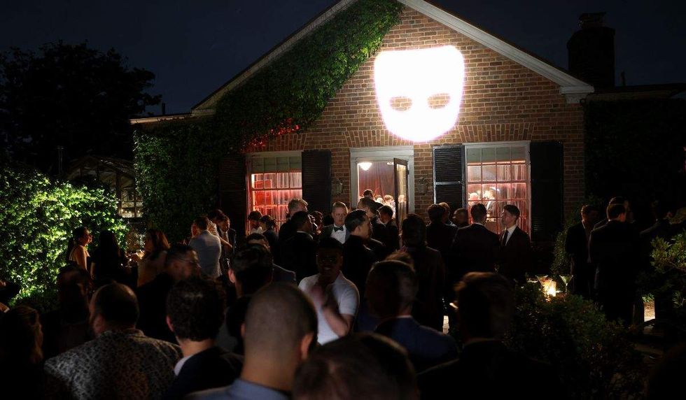 grindr logo projected onto the exterior of a building