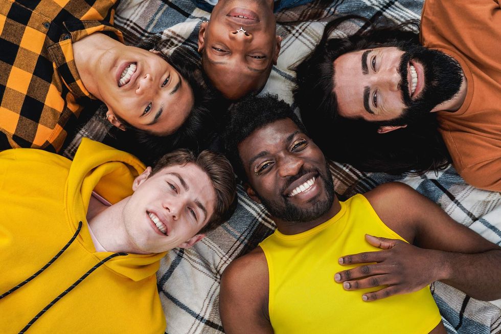 Group of gay men laying on a blanket