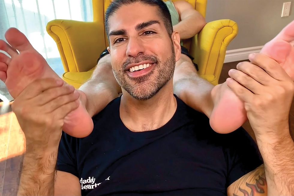 Guy Ruben touching someone's feet