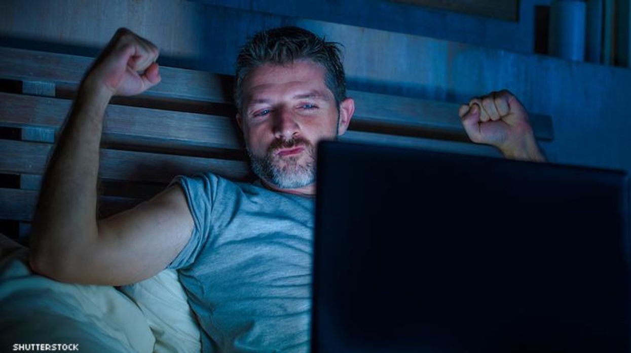 Guy watching computer screen while in the dark.