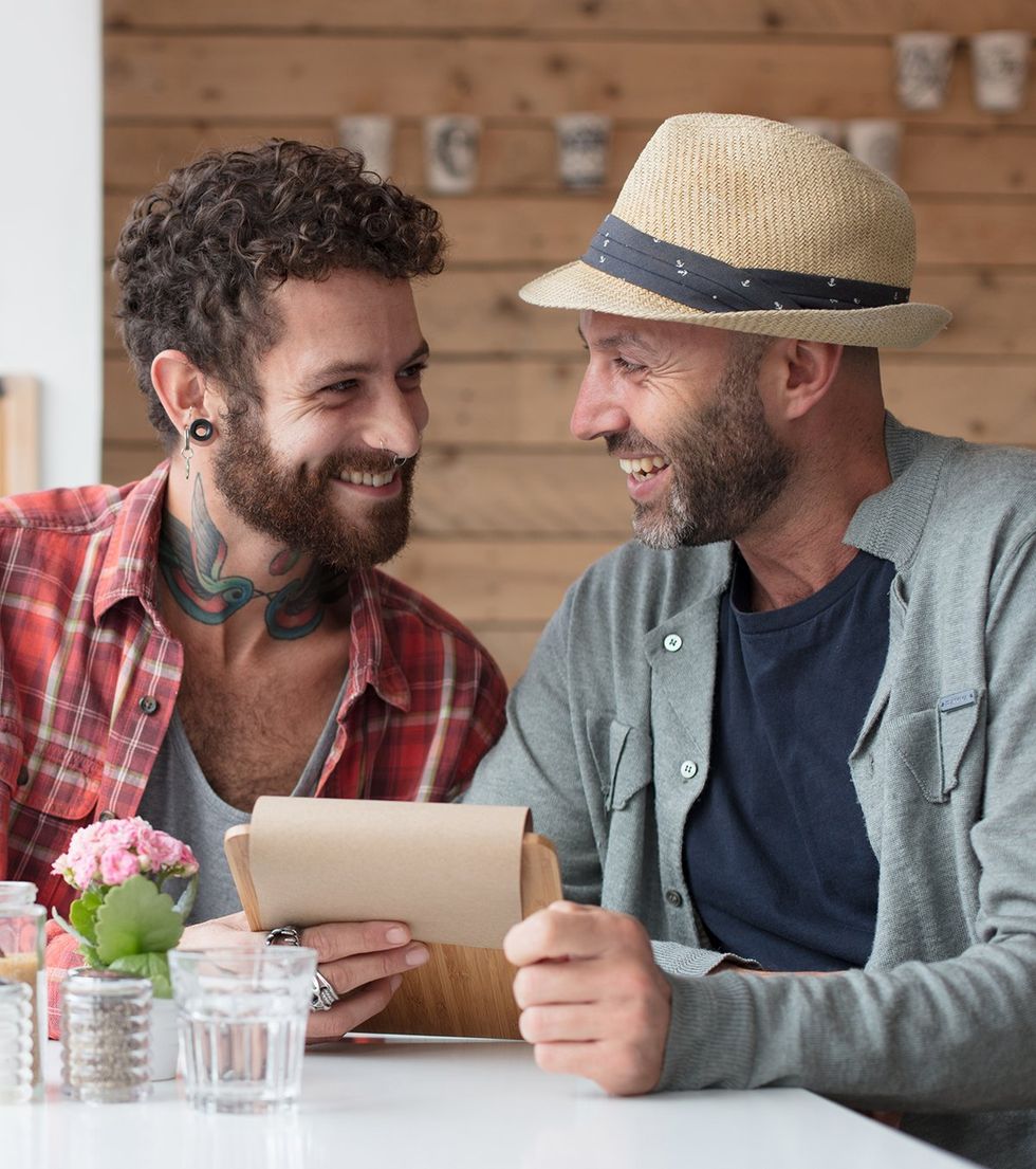 happy gay couple ordering food