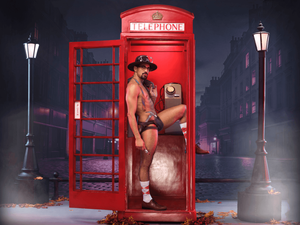 Hector Juan Maisonet as Inspector Gadget poses in a trench coat and hat inside a red London phone booth on a nighttime street set