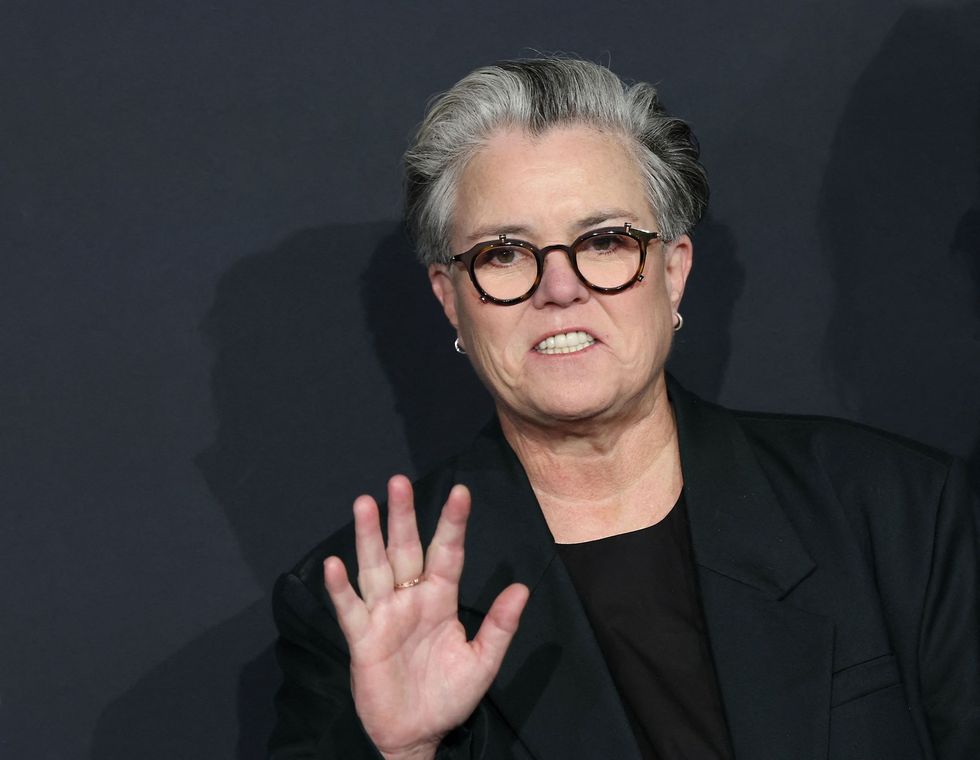 Image may contain: rosie o'donnell, face, head, person, photography, portrait, body part, finger, hand, adult, and blazer