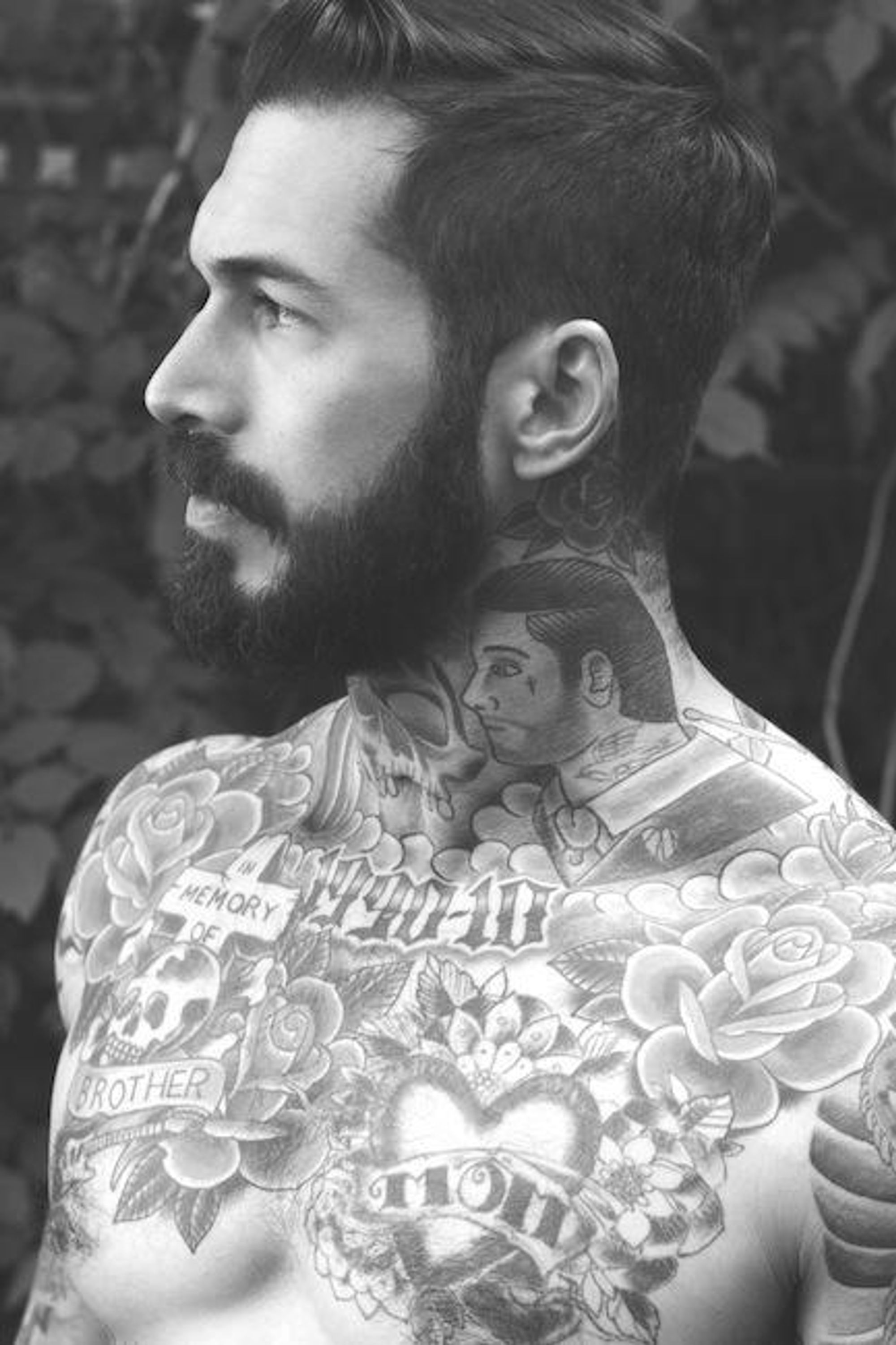 Black-and-white side portrait of Alex Minsky showing portrait imagery across the neck and shoulder