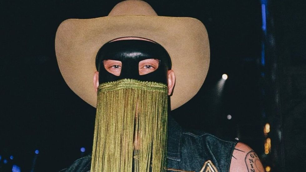 
Orville Peck just teased his face on Instagram & now fans are extra thirsty
