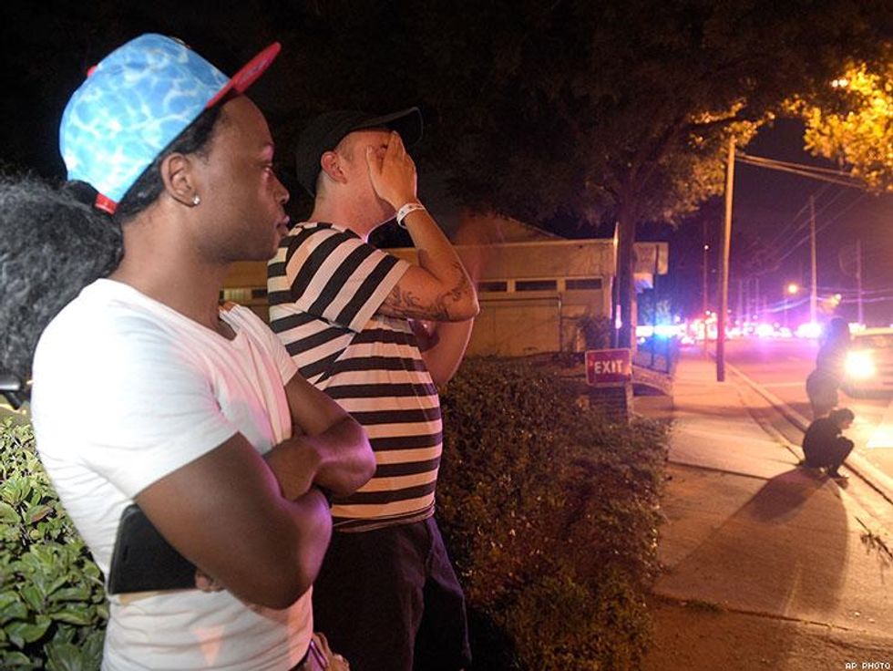 Jermaine Towns (left) and Brandon Shuford wait down the street from the multiple shooting at Pulse nightclub in Orlando.