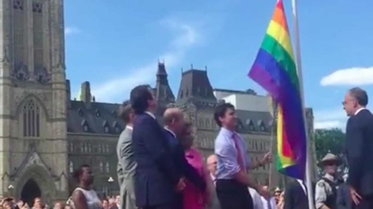 Justin Trudeau raises the Pride flag.