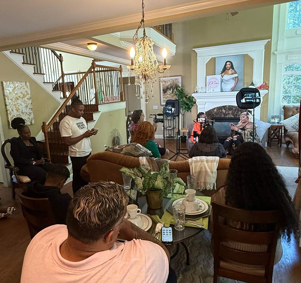 Kelley Robinson of HRC and TS Madison surrounded by journalists in the living room of TS Madisons Georgia home October 2025