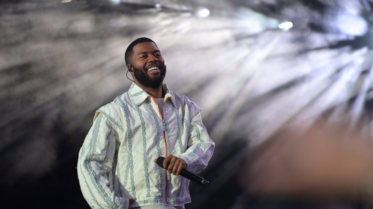 Khalid performing on stage with a microphone in his hand