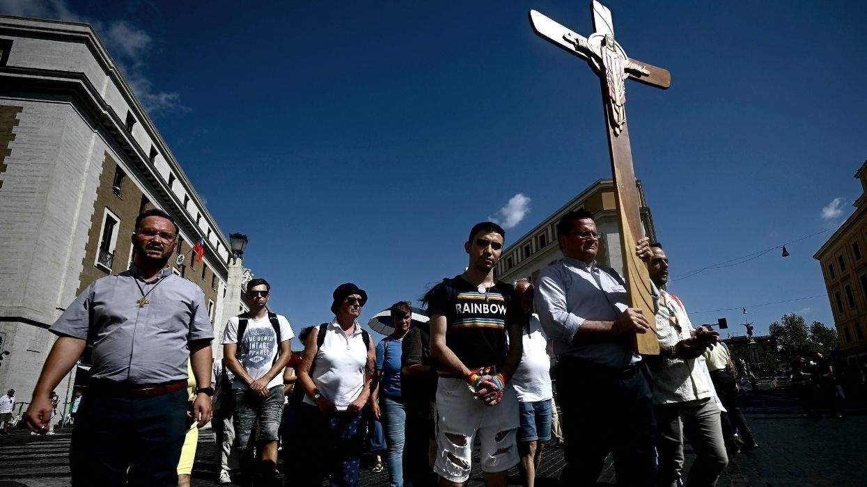 lgbtq catholics marching with a cross