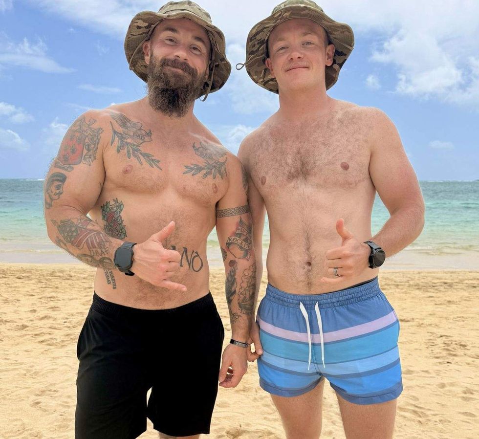 logan ireland and clayton mccallister - two men on the beach, shirtless, wearing shorts and a camouflage hat