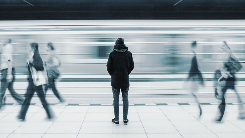 Loneliness epidemic threatens LGBTQ+ community; gay man alone on the subway