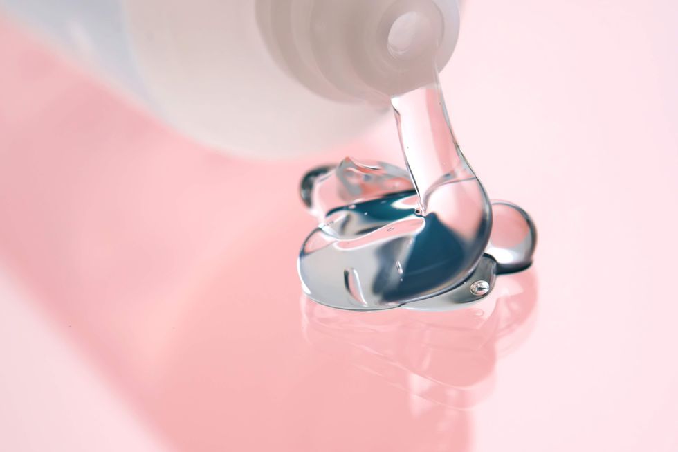 Lube being squeezed out on a pink surface