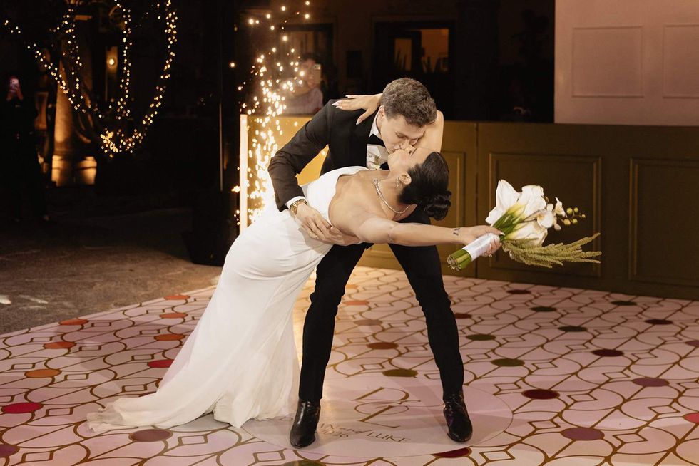 Luke Lowrey and Damian Terriquez kissing at their wedding.