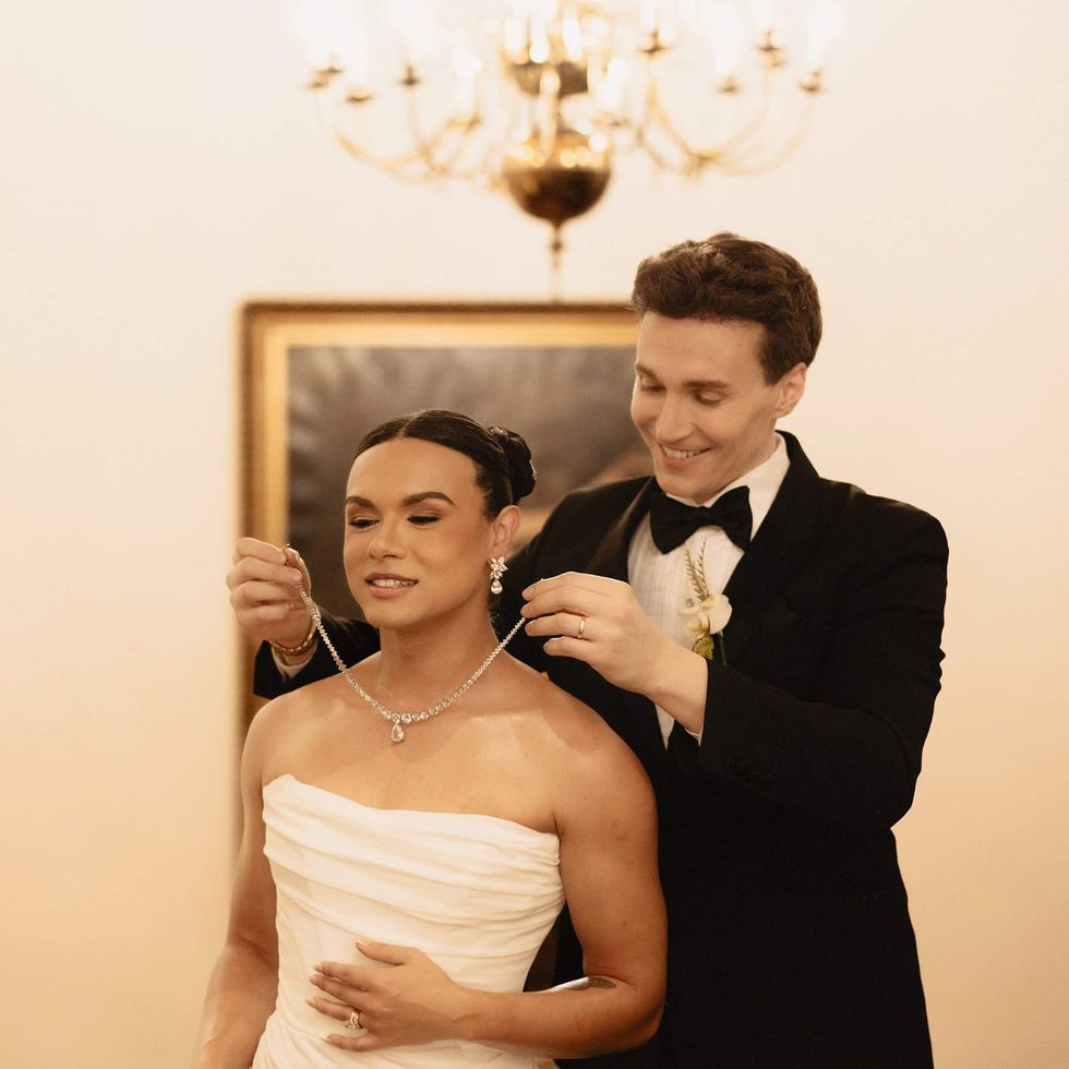 Luke Lowrey (right) putting a necklace on Damian Terriquez