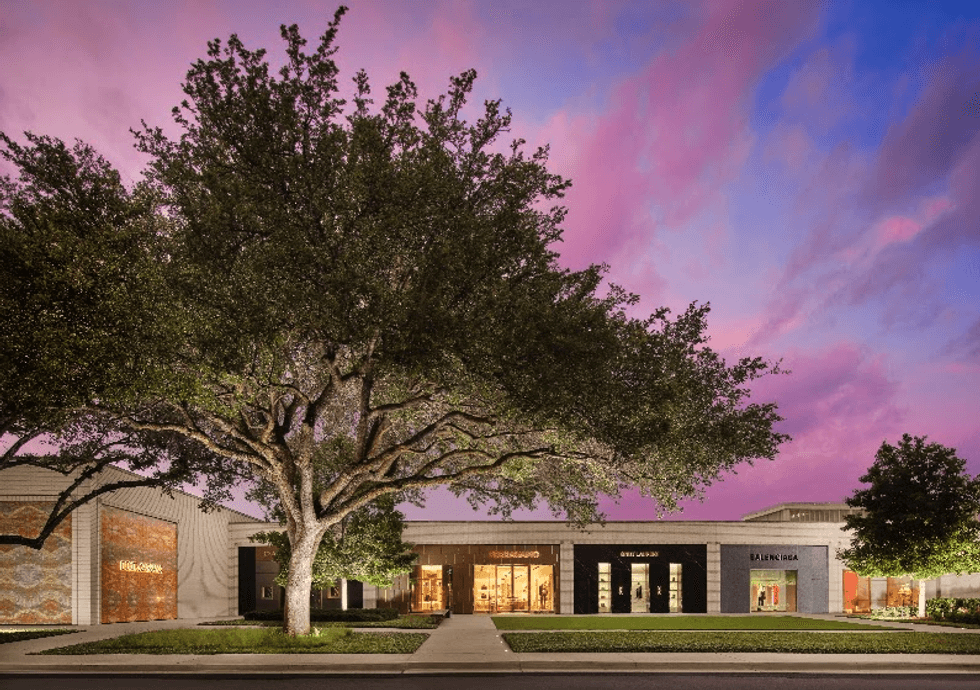 Luxury storefronts at NorthPark Center in Dallas beneath a colorful evening sky.