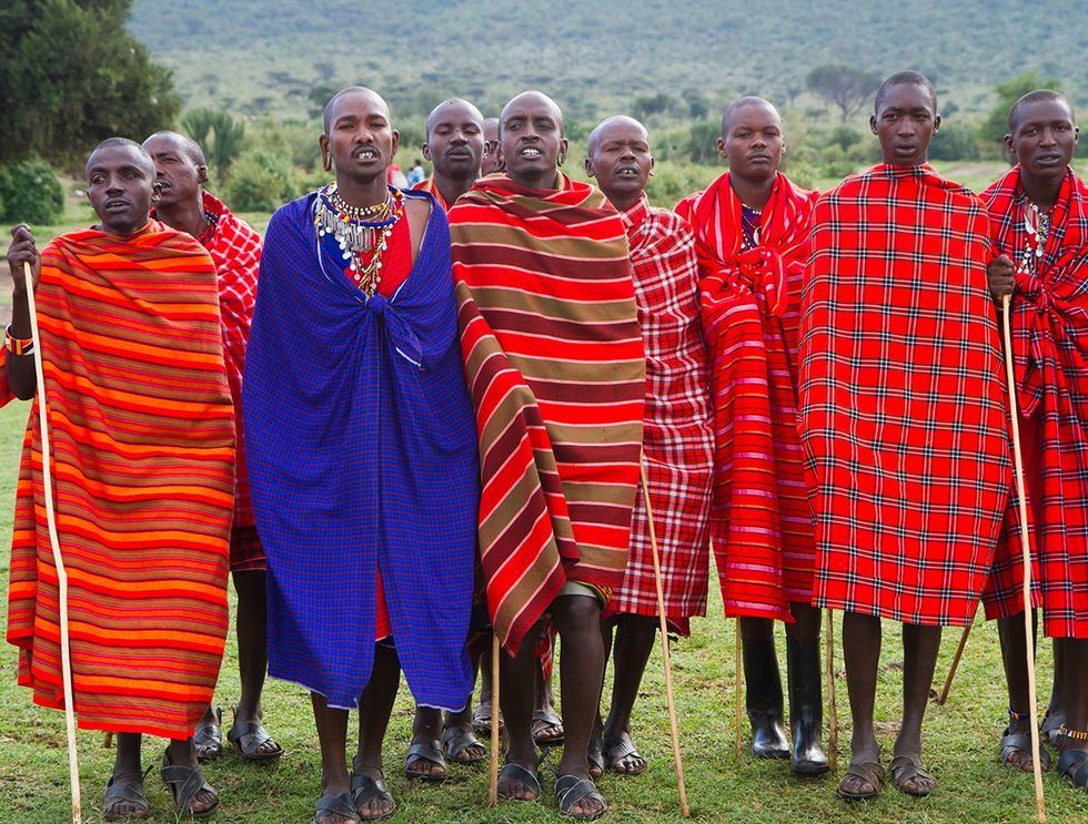 Maasai men gathering for jumping dance ceremony masai people still live with traditional dress and customs in Arusha Tanzania