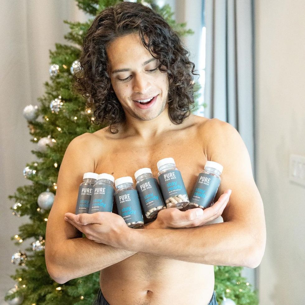 Man coddling a batch of Pure For Men fiber and cleanliness pills