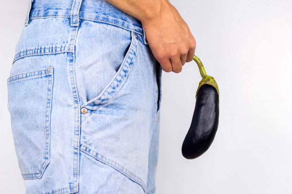 Man holding an eggplant.