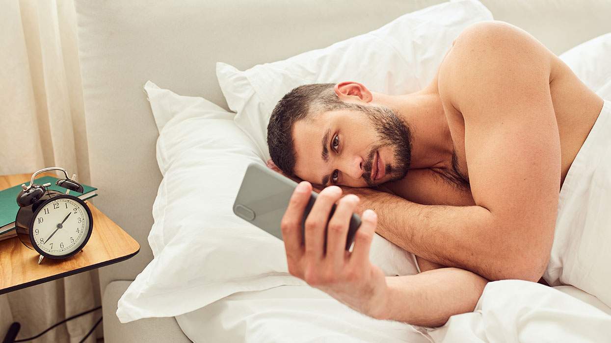 Man in bed with phone