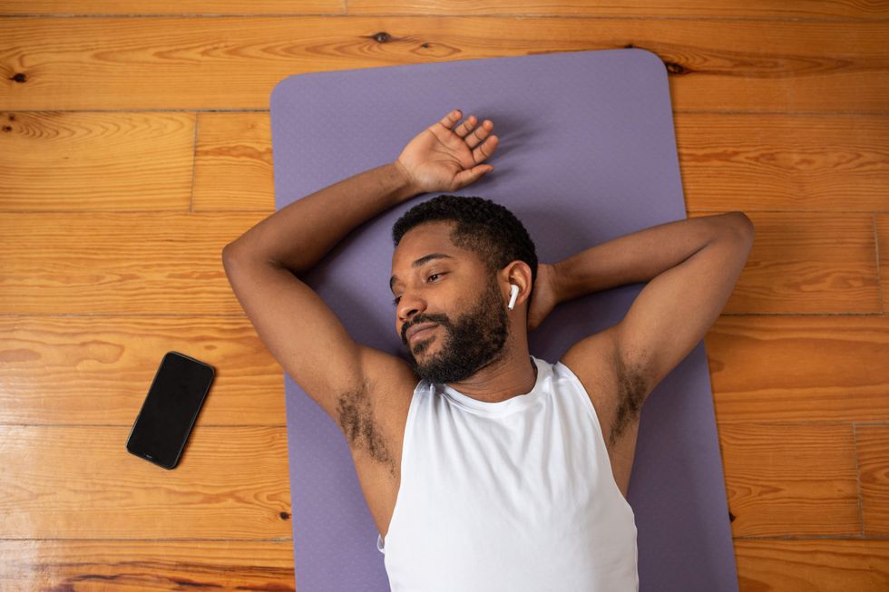 Man lying on a yoga mat.