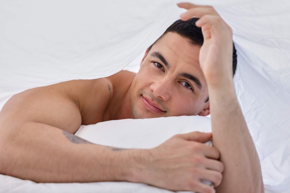 Man under the covers in bed