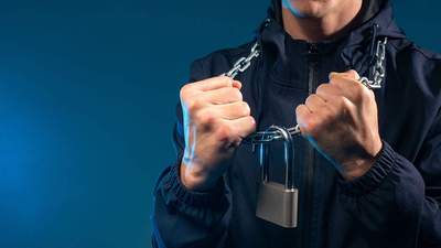 man wearing padlock necklace