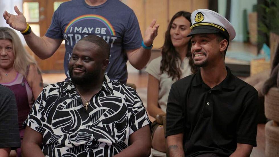 Marc-Sully St. Fleur as PJ smiling beside Anthony Norman in Jury Duty season 2