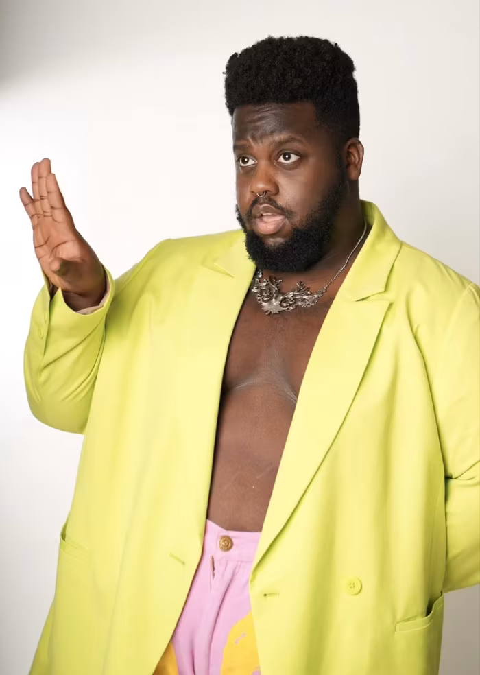 Marquis The Honey Bear in a neon green jacket with no shirt