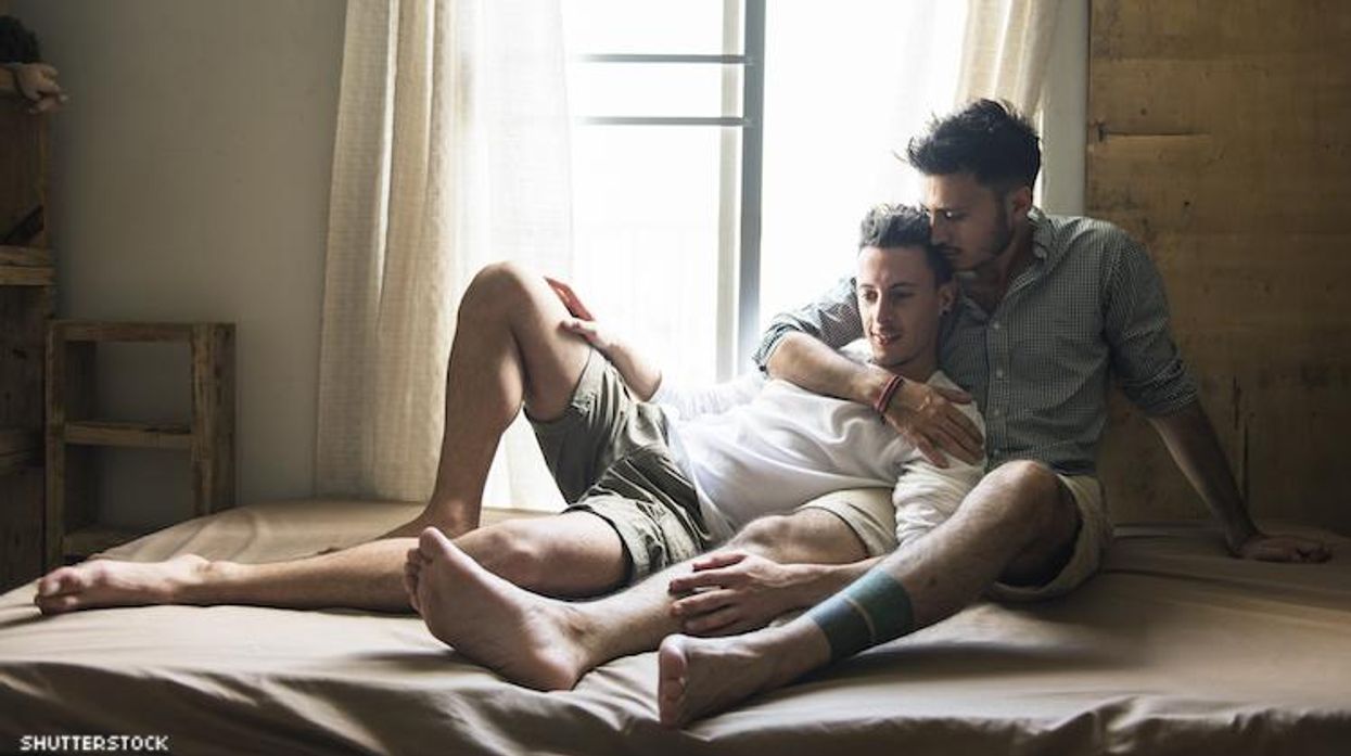 Men in bed Shutterstock