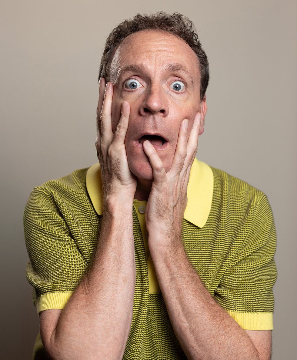 MESSY WHITE GAYS show Drew Droege at the center of a long feast table full of lavish colorful stage props