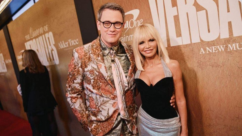 Michael Arden and Kristin Chenoweth posing on a red carpet