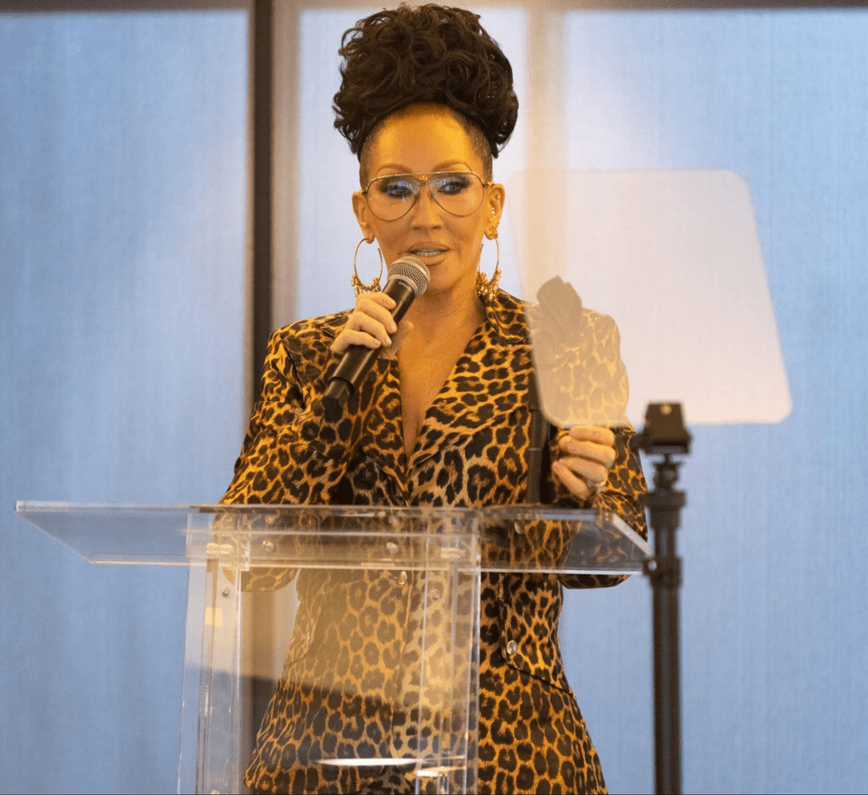 Michelle Visage at a podium speaking at the Point Foundation graduation