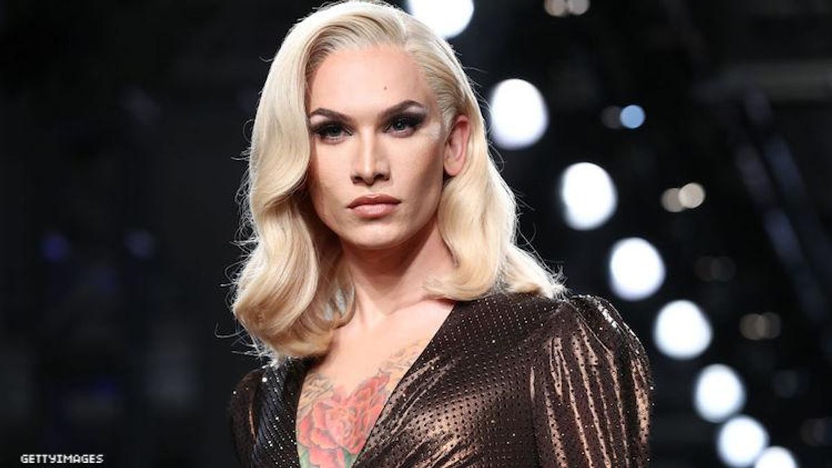 Miss Fame walking in a fashion show. 