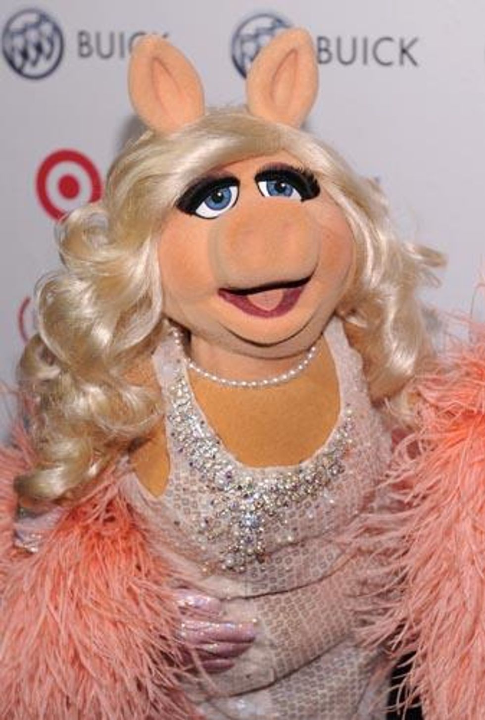 Miss Piggy walks the red carpet at the Out100 party