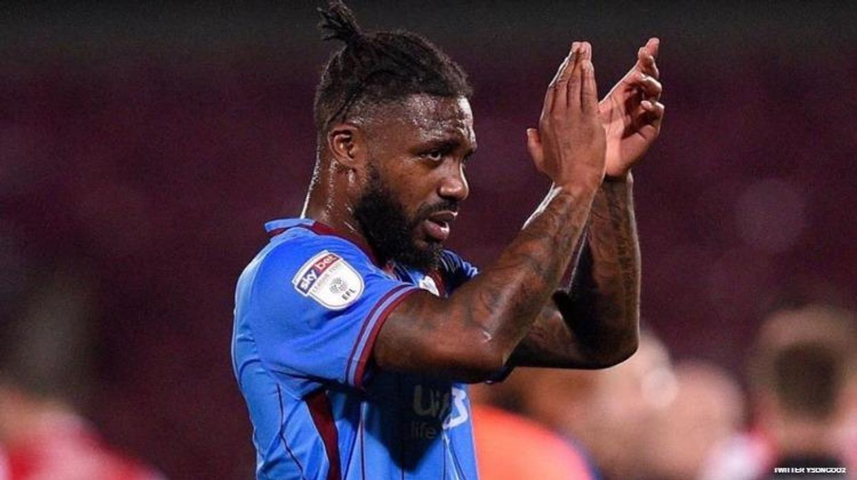 Morecambe FC soccer star Yann Songo'o faces 12-game suspension for hurling homophobic slur at opposing player during League 2 play in January.