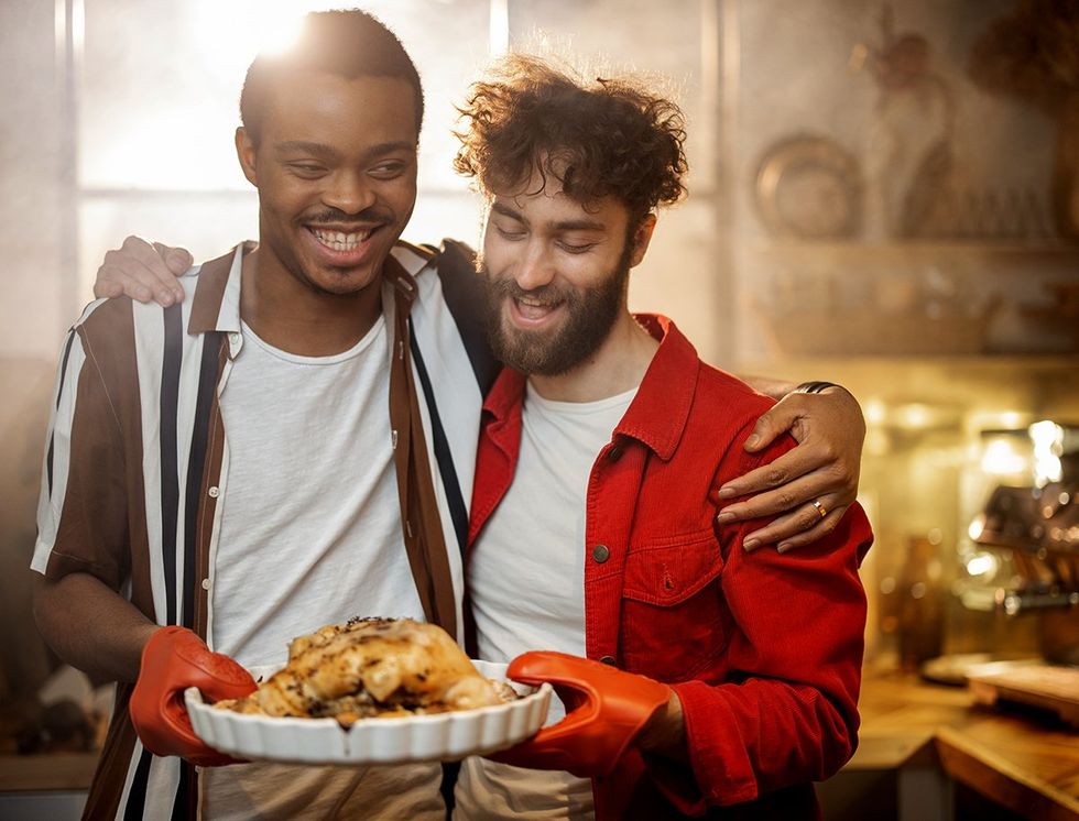 multi racial gay couple making dinner happy supportive environment