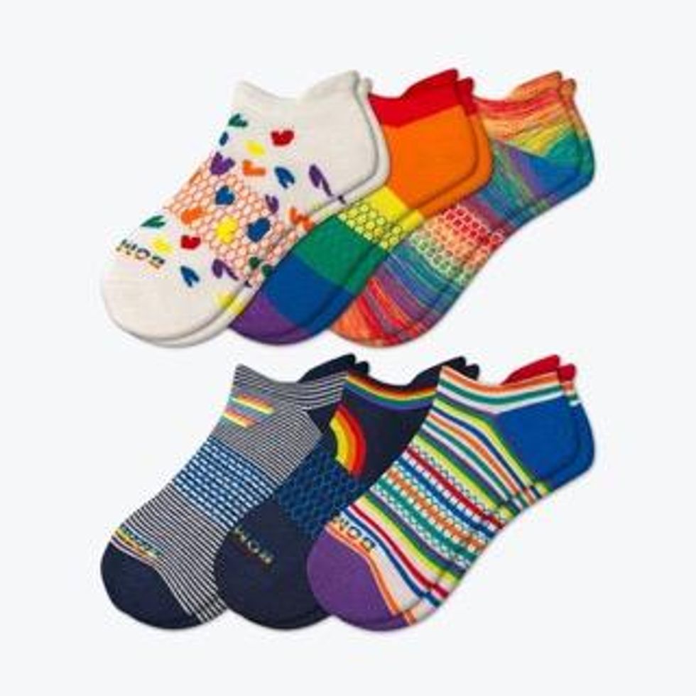 Multiple pairs of rainbow socks lined up neatly in two parallel rows