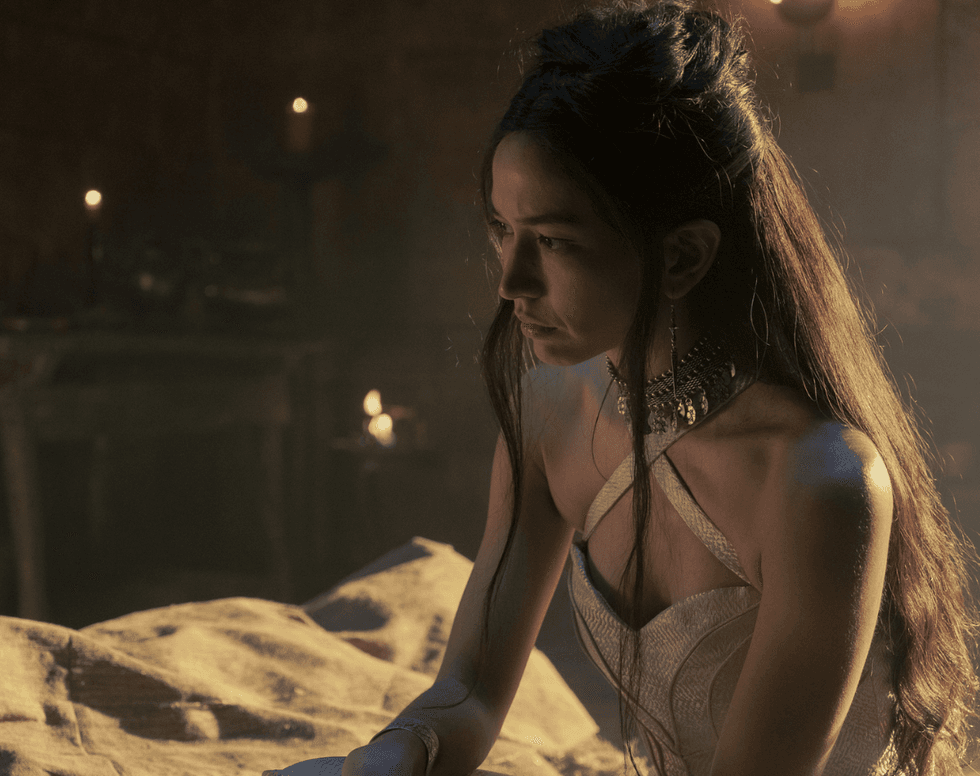 Mysaria sits on a cot