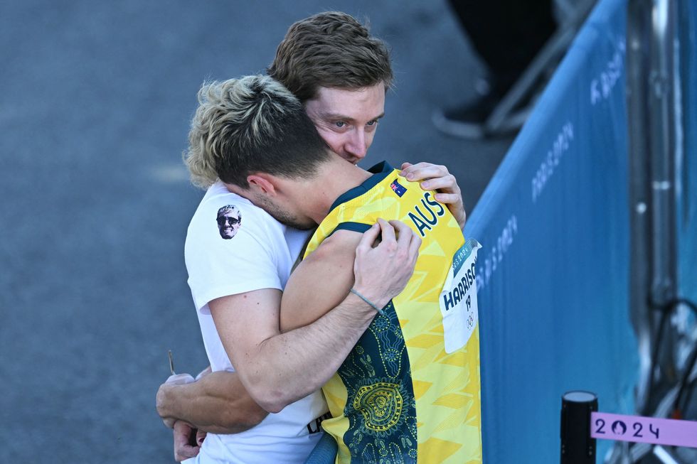 Olympic rock climber Campbell Harrison kisses his boyfriend.