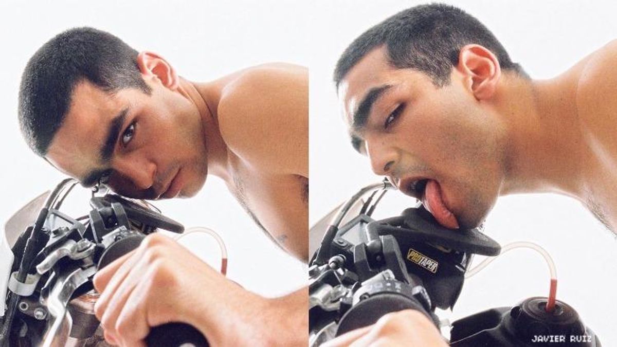 Omar Ayuso licking a motorcycle.