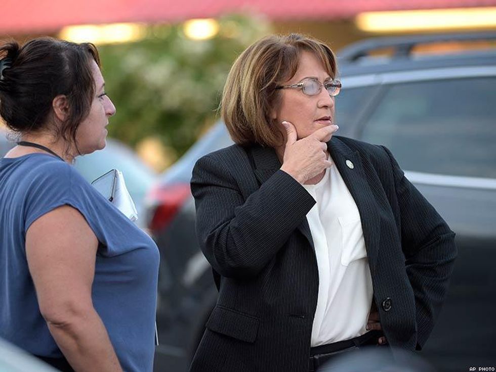 Orange County Mayor Teresa Jacobs, right, is briefed after arriving to the scene.