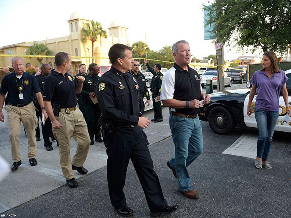 Orlando Mayor Buddy Dyer, second from right, and Orlando Police Chief John Mina arrive to a news conference.