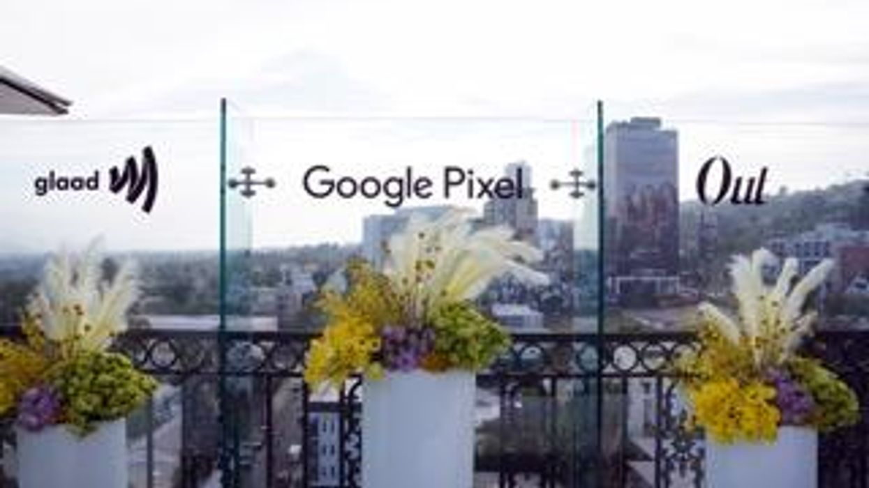 panoramic view of LA skyline with Glaad Google and Out Magazine logos each with a floral arrangement